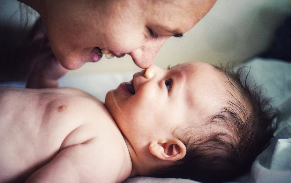 baby smiling at mom
