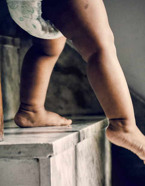 baby walking down the stairs with dad 