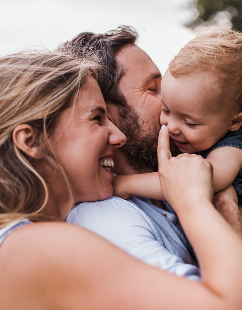 Happy family of three outside in nature 