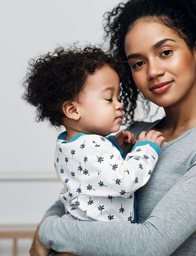 mom carrying baby on arm