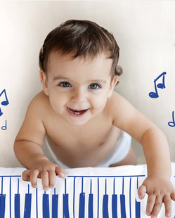 Bebe sonriente con piano