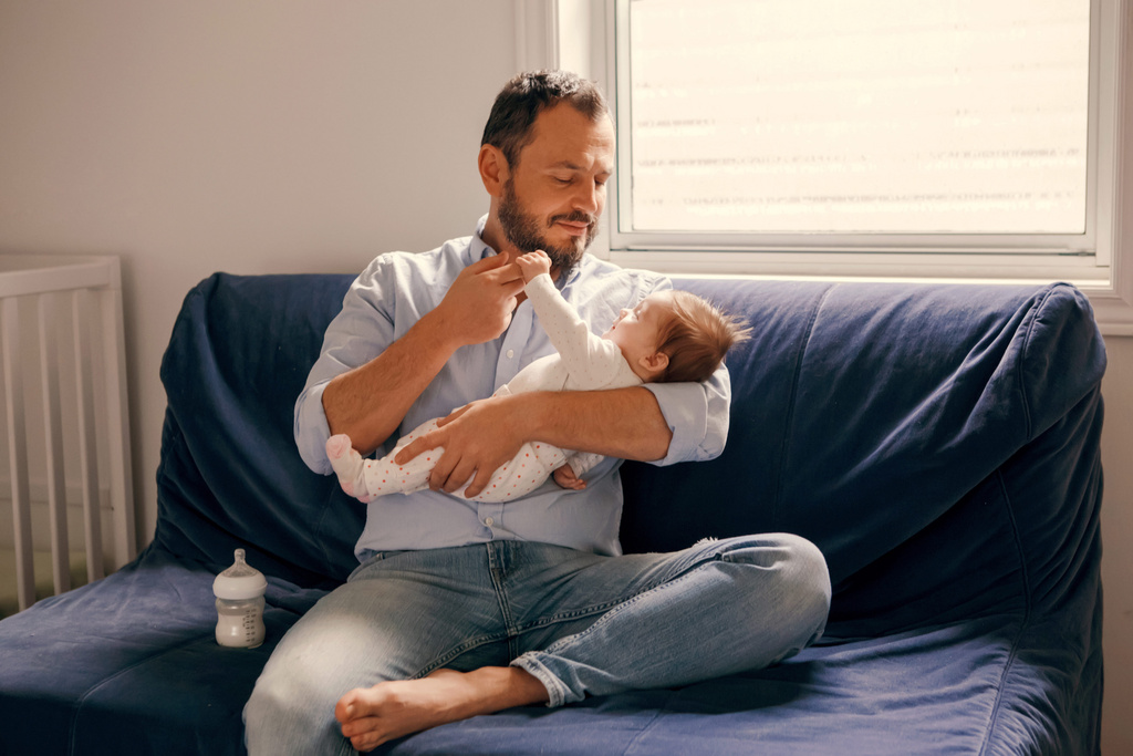 baby holding dads finger 