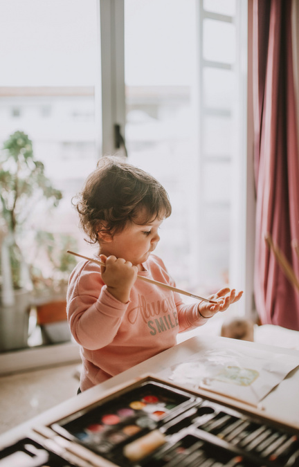 toddler with paintbrush